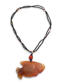 A CHINESE RED AGATE CARVED GOLDFISH PENDANT