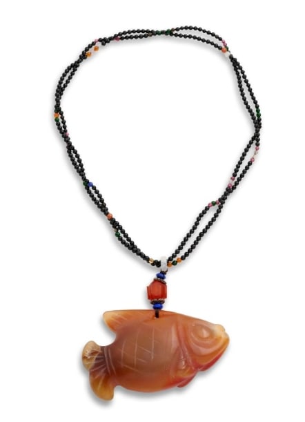 A CHINESE RED AGATE CARVED GOLDFISH PENDANT