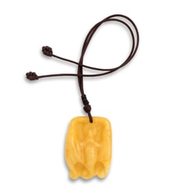 A CHINESE YELLOW AMBER CARVED PENDANT