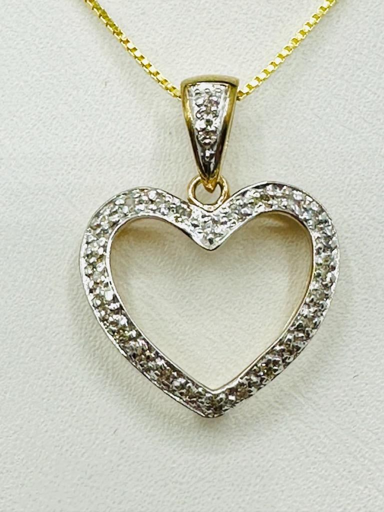 14KT Yellow Gold Natural Diamond Heart Pendant and Chain # 2010: # 2010 14KT Yellow Gold Natural Diamond Heart Pendant and Chain 26 pcs diamond 0.20 carat (t.w.) 16” box chain with lobster lock clasp closure Pendant and Chain Weight: 3.00 grams Pendant: 23 mm