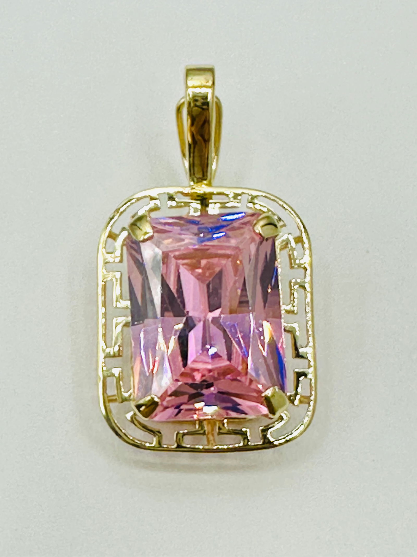 14KT Yellow Gold Pink Iced Pendant # 2662: # 2662 14KT Yellow Gold Pink Iced Pendant 1 piece emerald cut pink iced Pendant Weight: 5.30 grams (t.w.) Pendant size: 30 mm X 16 mm