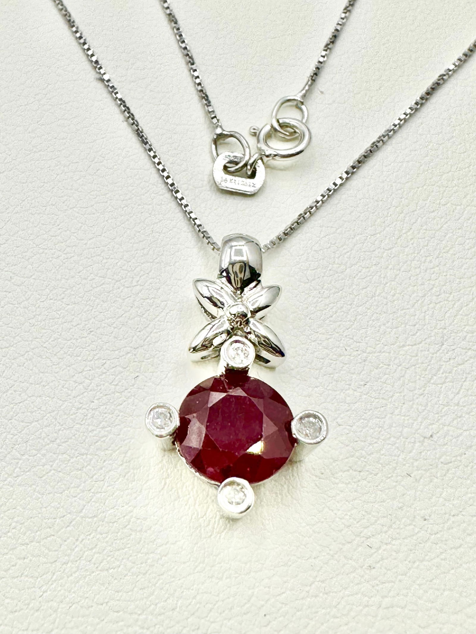 14KT White with Natural Diamond and Ruby Pendant with 18" Box Chain - J11129: * Natural Diamond and Ruby Pendant with 18” Box Chain. * 14KT White Gold * 4 pcs diamond 0.05 Carat ( t.w.) * Clarity VS-SI, Color G-K * 1pc round natural ruby 1.28 Carats (t.w.) * Pendant & Cha
