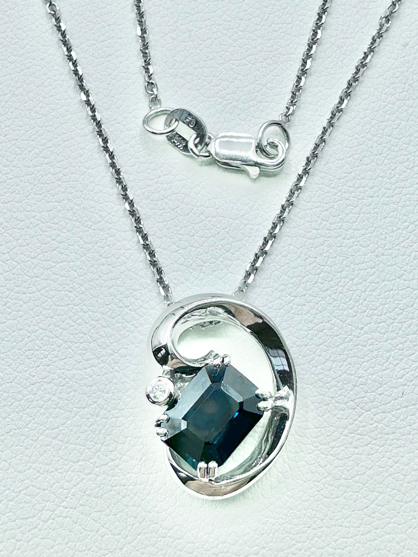 Natural Sapphire & Diamond Pendant with 18" Cable Chain in 14KT White Gold - J11131: * Natural Sapphire & Diamond Pendant with 18” Cable Chain * 14KT White Gold * 1 pc diamond * Clarity VS-SI, Color G-K * 1 pc emerald cut sapphire 1.66 Carats * Pendant & Chain Weight 3.90 grams