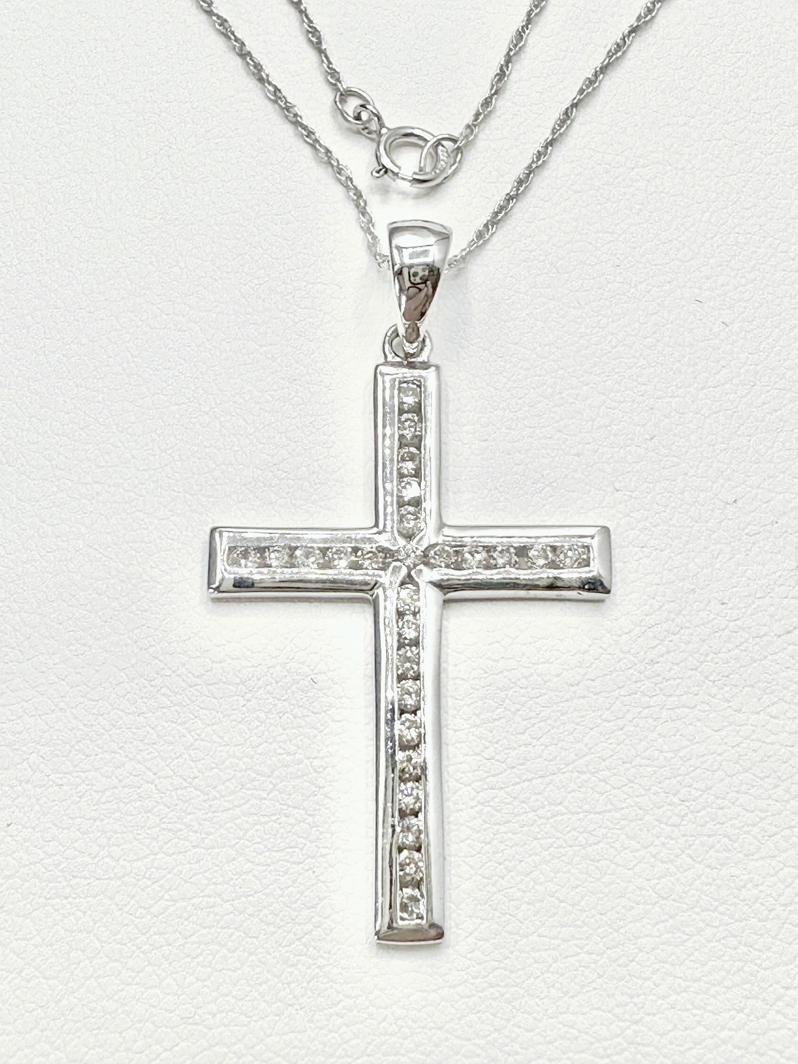 14KT White Gold With 26 Pcs Channel Set Diamond Necklace - J11149: * Natural Diamond Cross Pendant and 18” Chain. * 14KT White Gold; * 26 pcs Channel set diamond 0.45 Carats(t.w.); * Clarity VS-SI, Color G-K; * Pendant and Chain Weight 2.90 grams(t.w.); * Sprin