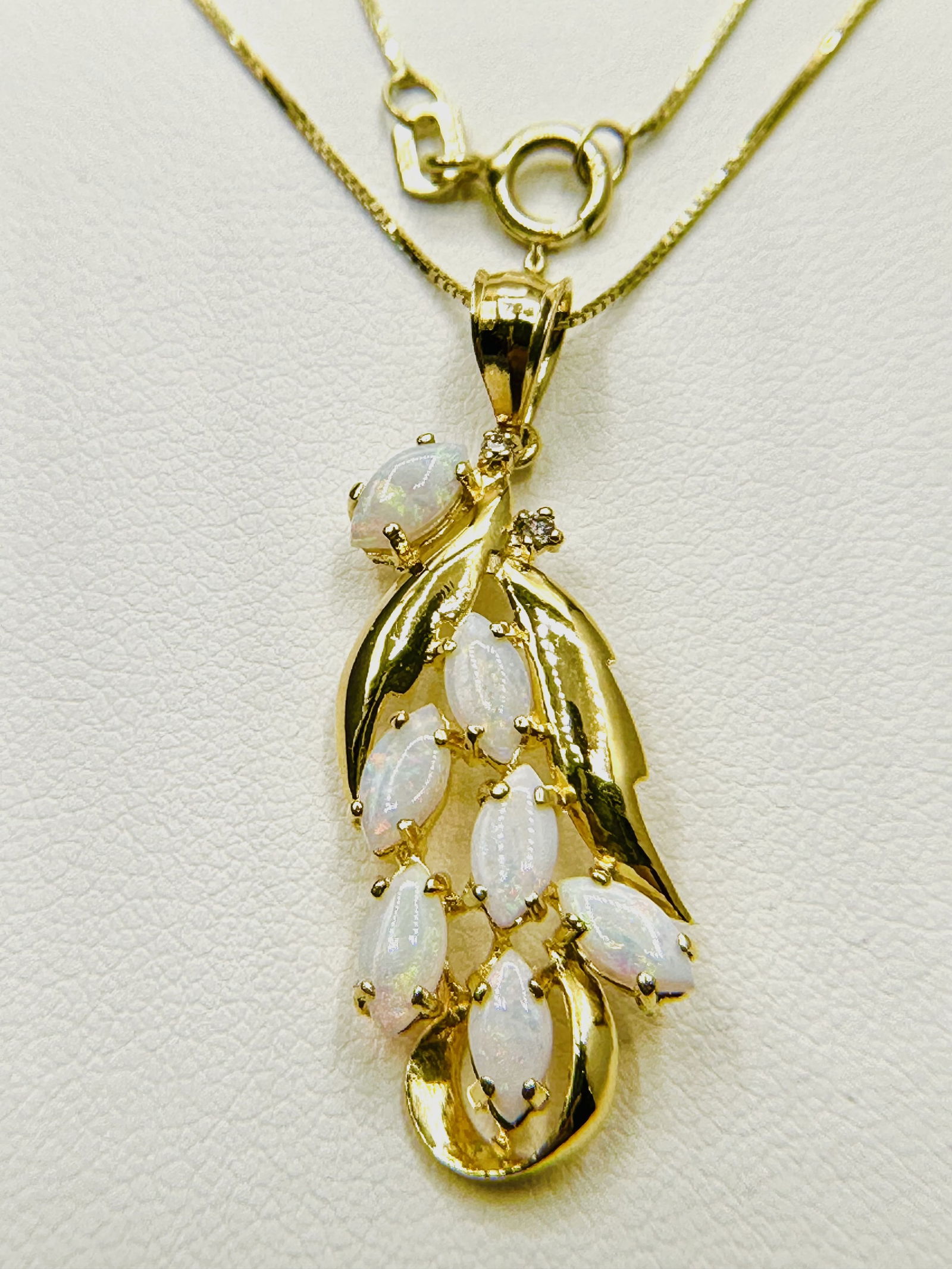14KT Yellow Gold Marquis Opal Pendant Necklace - J11169: * 14KT Yellow Gold Marquis Opal Pendant with 2 pcs diamond and 18” box Chain * 7 pcs opal 6 x 3mm * Pendant and Chain Weight 2.90 Grams * Pendant Measurement 35 mm x 11.50 mm * Spring ring clasp