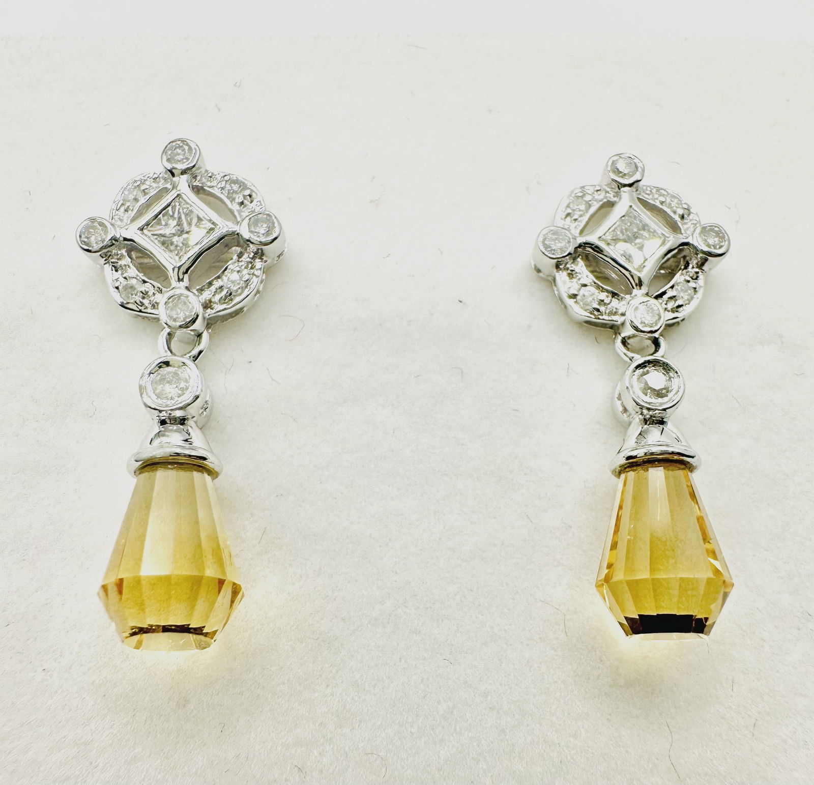 14 KT White Gold Natural Diamond And Citrine Earrings - J11244: *14 KT White Gold Natural Diamond and Citrine Earrings *20 Pcs Round and Princesses Cut Diamond 0.60 carat(t.w.) *2 pcs citrine *Push Backs *Earrings Weight: 3.80 grams, *Diamond Clarity VS-SI, Color