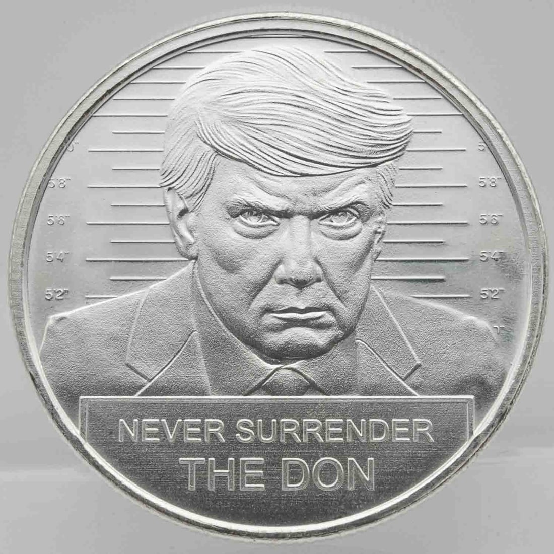 Donald Trump Mug Shot Never Surrender 1oz Silver Round: Subject: Donald Trump Mug Shot Never Surrender 1oz Silver Round Medium: 999 Silver Year: Condition: MS Note: Any condition statement is given as an opinion and should not be treated as a statement of