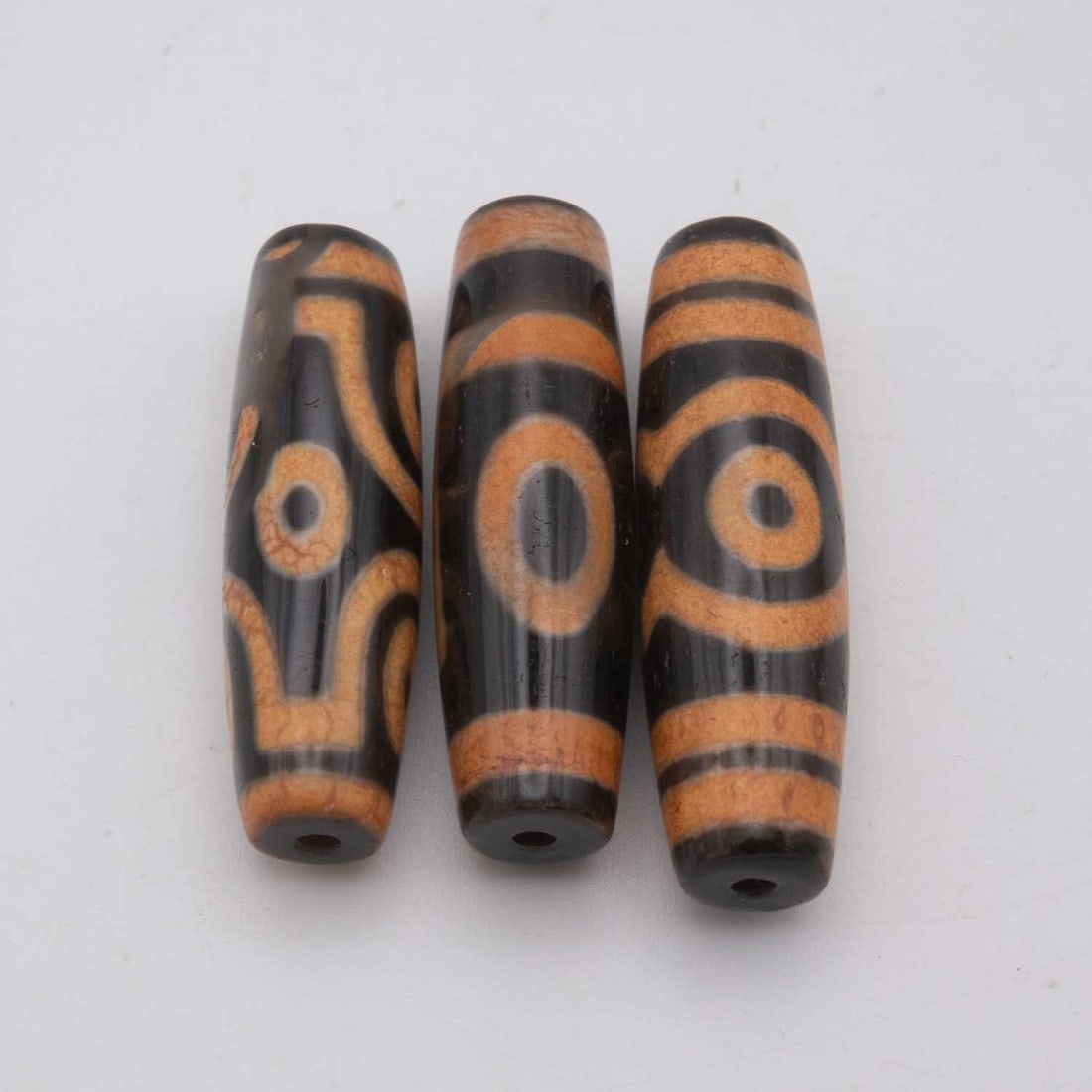 Lot Of 3 Chinese Tibetan Agate Dzi Beads: Medium: AgateSize: 1.8x0.5 inchesAge/Detail: Lot Of 3 Chinese TibetanCondition: great overall, check photo for condition reference.Provenance:Collection from Estate in WilliamsburgLiveShipping is NOT