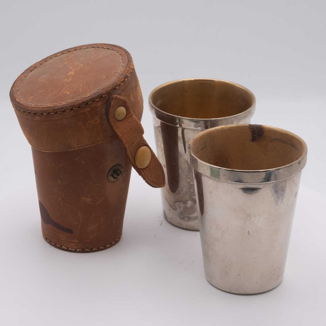 Vintage Travel Metal Drinking Cup With Leather Case: Medium: Metal Size: 3.5x3x2.5 inches Age/Detail: Vintage Travel Condition: great overall, check photo for condition reference. Provenance: Collection from Estate in Williamsburg LiveShipping is NOT