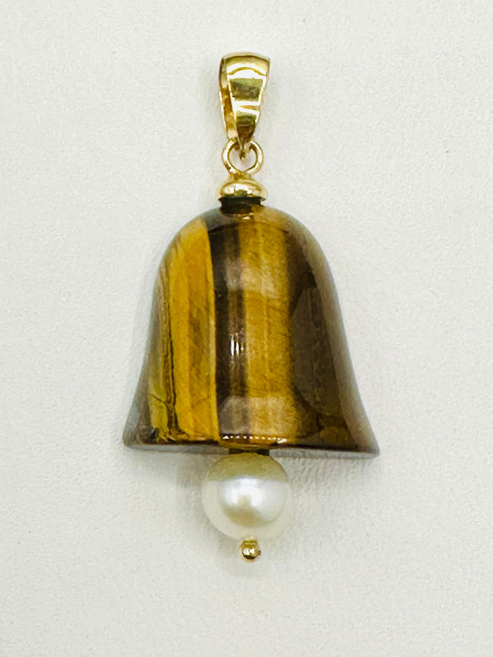 14KT Yellow Gold Tiger Eye Pendant with Pearl # 2505: # 2505 14KT Yellow Gold Tiger Eye Pendant with Pearl 1 piece freshwater pearl Pendant Weight: 2.40 grams(t.w.) Pendant size: 30 mm X 19 mm