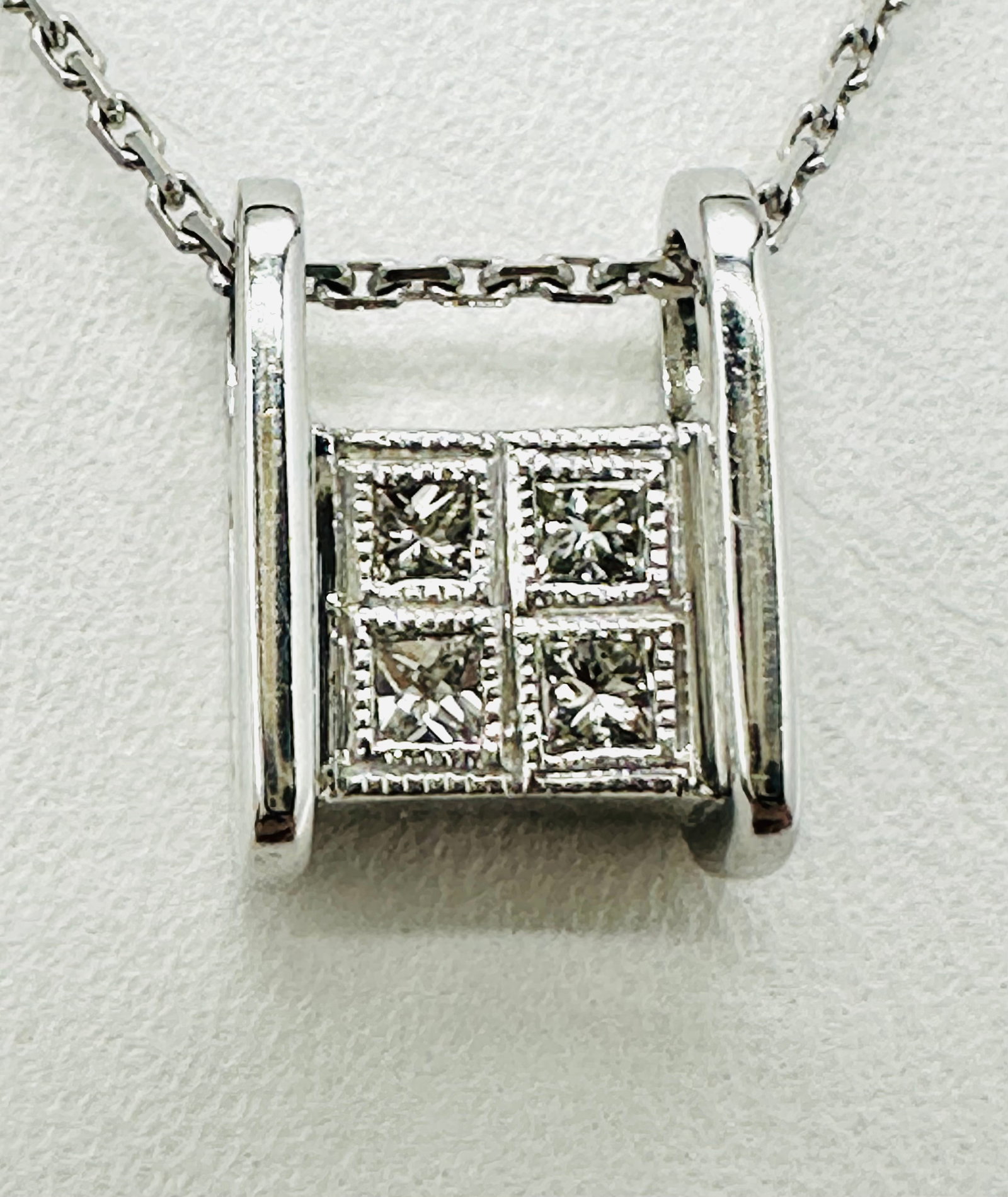 Natural Diamond and Ruby Double Sided Pendant with Chain 18KT White Gold # 2544: # 2544 Natural Diamond and Ruby Double Sided Pendant with Chain 18KT White Gold 4 pieces diamond 0.18 carat( t.w.) 4 pieces ruby 0.25 carat(t.w.) 16” chain with lobster lock clasp closure Pendan