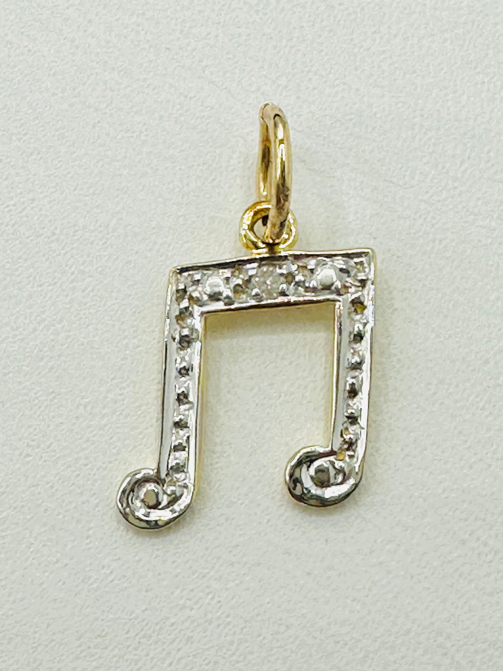14KT 2Tone Gold, Natural Diamond Music Notes Charms # 2702: # 2702 14KT 2Tone Gold, Natural Diamond Music Notes Charms 1 piece diamond Weight: 0.70 grams (t.w.) Pendant size: 17 mm X 9 mm