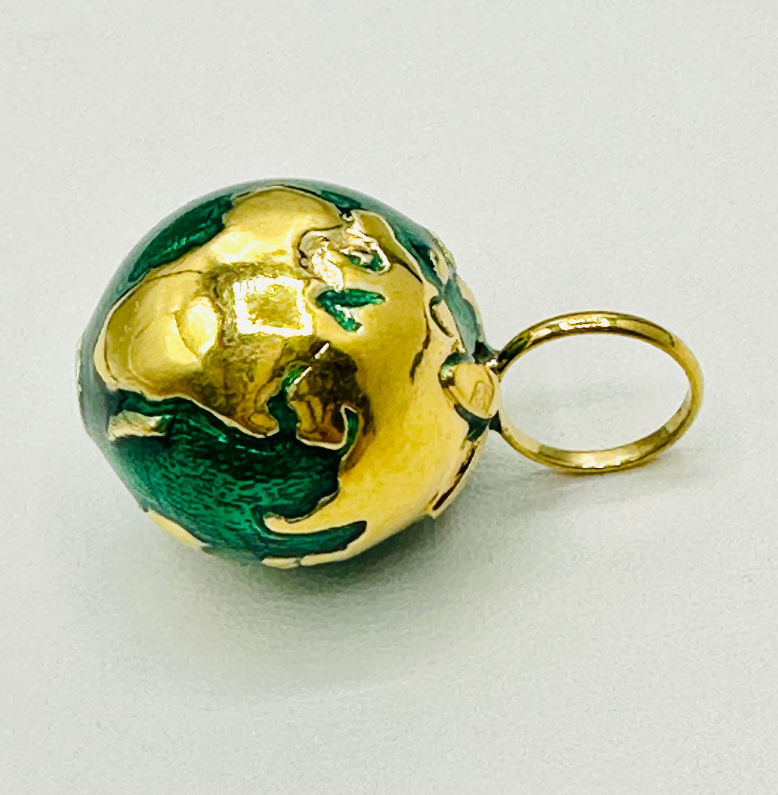 18KT Yellow Gold, Globe Charm With Enamel # 2706: # 2706 18KT Yellow Gold, Globe Charm With Enamel Weight: 2.00 grams (t.w.) Size: 15 mm X 17 mm
