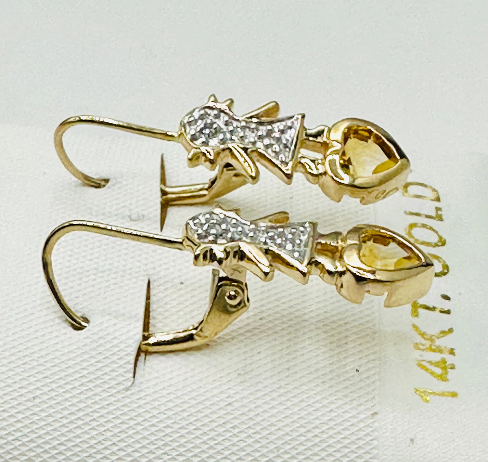 Pair of Natural Diamond and Yellow Topaz Earrings, 14KT Yellow Gold # 2558: # 2558 Pair of Natural Diamond and Yellow Topaz Earrings, 14KT Yellow Gold 2 pieces diamond 0.02 carat(t.w.) 2 pieces heart shape yellow topaz Earrings Weight: 2.70 grams(t.w.) Lever-backs Closure App