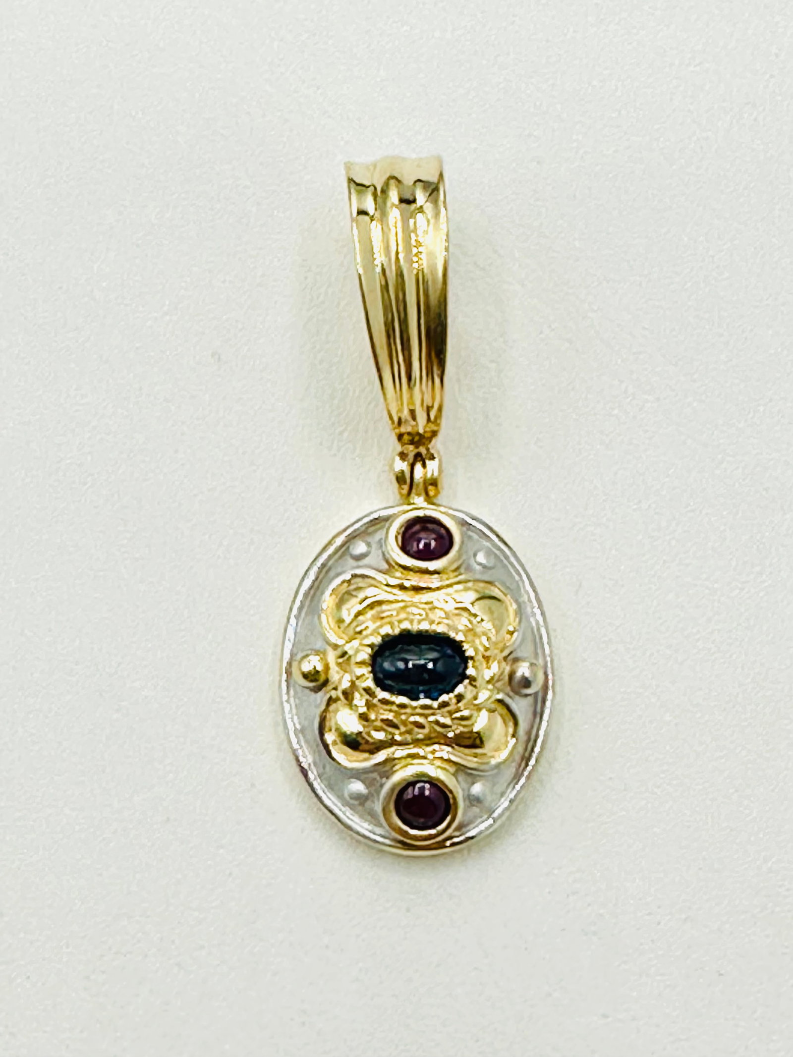 14KT Yellow Gold, Ruby and Sapphire oval Pendant # 2565: # 2565 14KT Yellow Gold, Ruby and Sapphire oval Pendant 2 pieces ruby 1 piece sapphire Pendant Weight: 5.00 grams (t.w.) Pendant size: 34 mm X 13.50mm