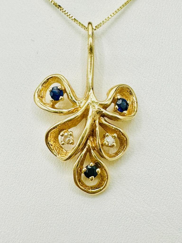 14KT Yellow Gold Natural Diamond and Sapphire leaf Pendant with Chain # 2065: # 2065 14KT Yellow Gold Natural Diamond and Sapphire leaf Pendant with Chain 2 pieces diamond 0.06 carat(t.w.) 3 pieces sapphire 0.15 carat(t.w.) 18” box chain with spring ring clasp closure Pen