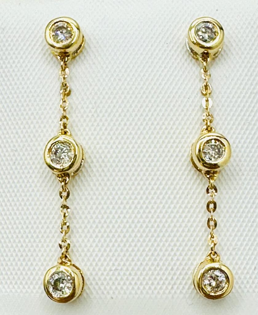 14KT Yellow Gold Pair of Natural Diamond Hanging Earrings # 2078: # 2078 14KT Yellow Gold Pair of Natural Diamond Hanging Earrings 6 Pieces Diamond 0.35 carat(t.w.) Earrings Weight: 1.70 grams Push backs Earrings size: 29 mm x 4.20 mm