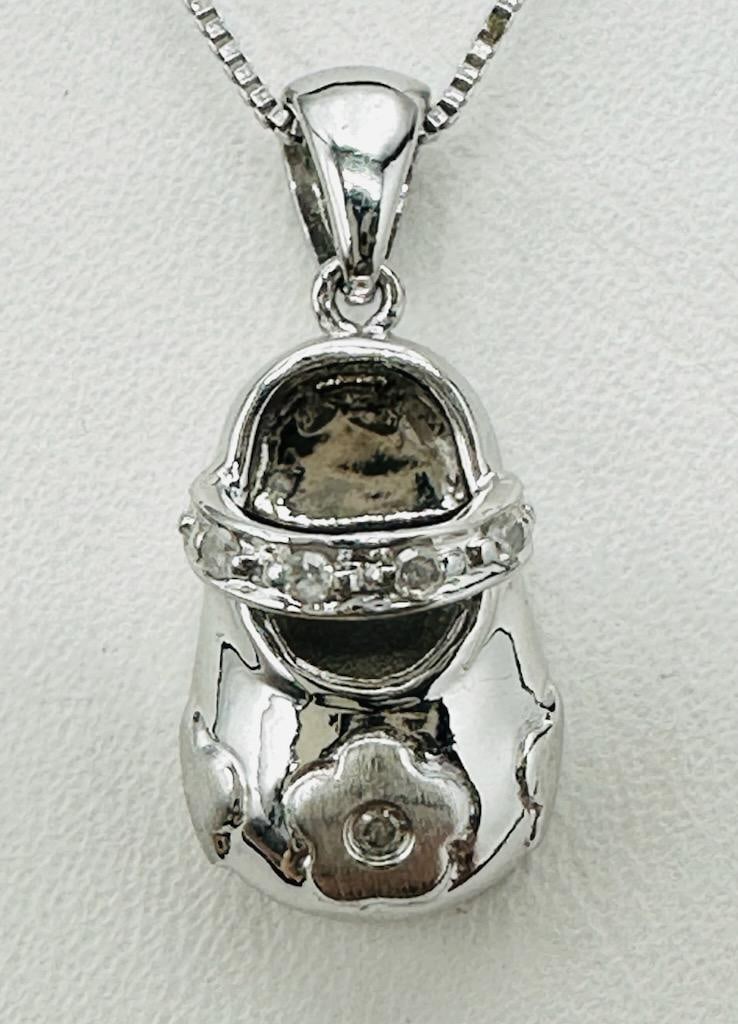 14KT White Gold Natural Diamond Lovely Baby Shoe Pendant and Chain # 2090: # 2090 14KT White Gold Natural Diamond Lovely Baby Shoe Pendant and Chain 5 pieces diamond 0.03 carat(t.w.) 18” box chain with spring ring clasp closure Pendant and Chain Weight: 3.30 grams Pend