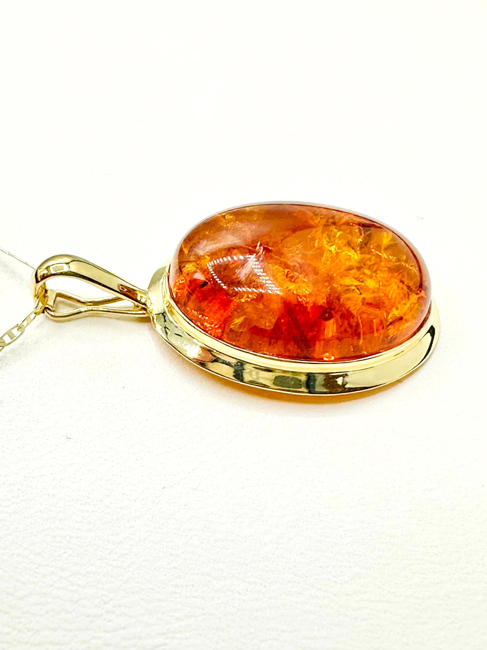 14KT Yellow Gold Amber Oval Pendant and Chain # 2208: # 2208 14KT Yellow Gold Amber Oval Pendant and Chain 18” chain with spring ring clasp closure Pendant and Chain Weight: 3.50 grams Pendant size: 23 mm x 18 mm