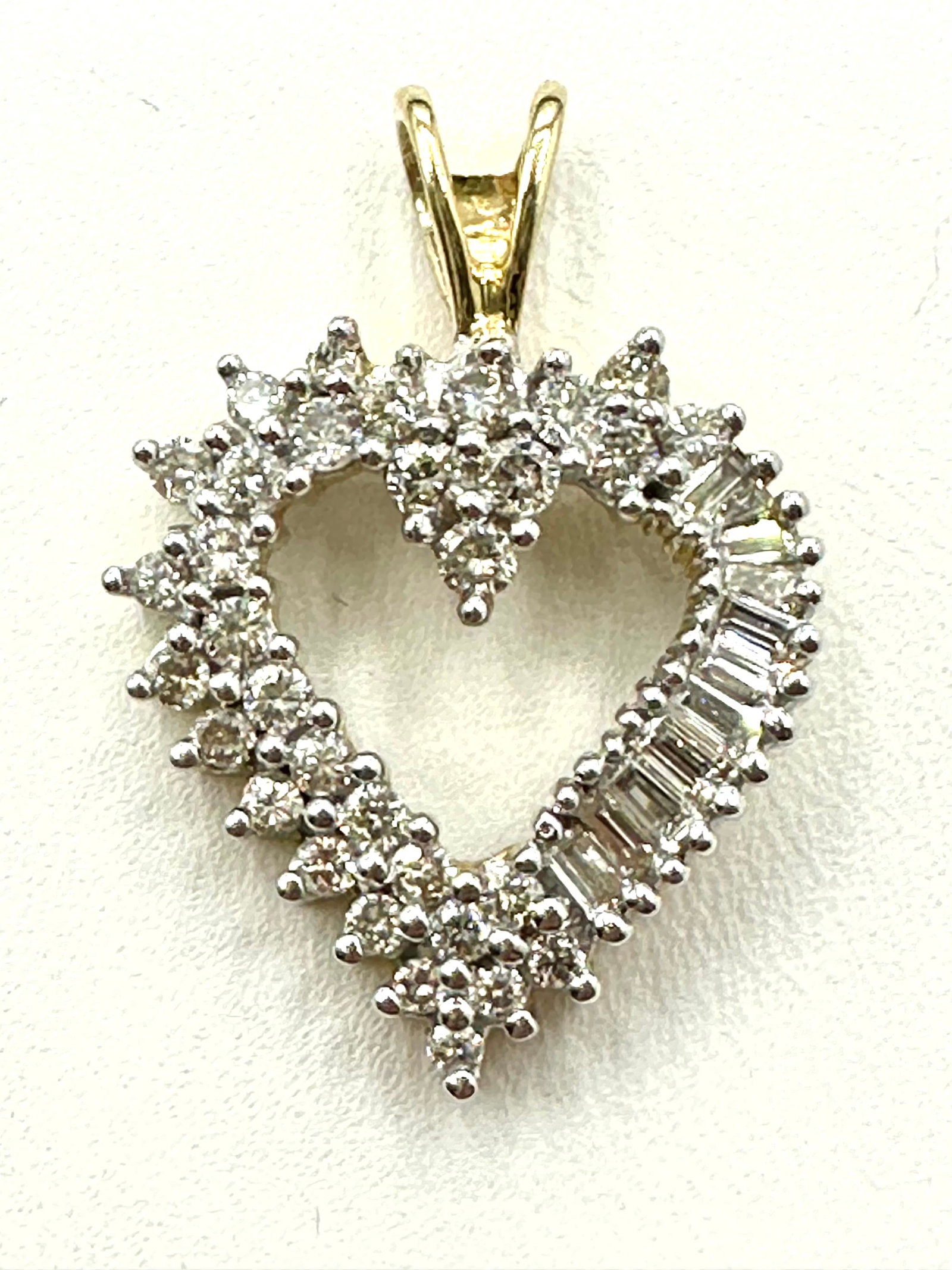 Natural Diamond 14KT Yellow and White Gold Heart Pendant # 2215: # 2215 Natural Diamond 14KT Yellow and White Gold Heart Pendant Round and Baguette Diamond 1.00 carat(t.w.) Weight: 3.70 grams Pendant size: 26 mm x 18.50 mm