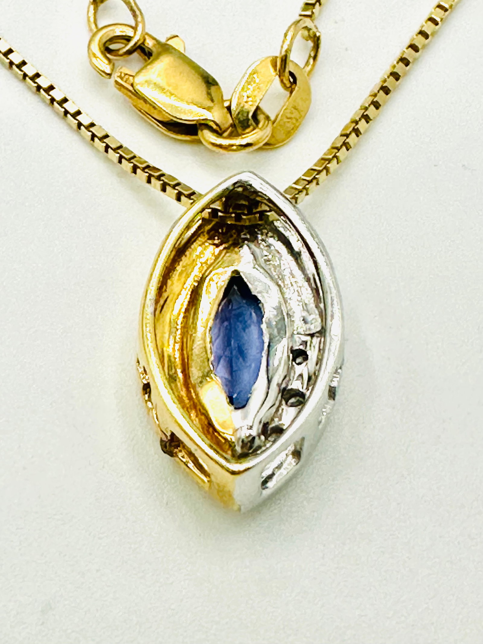 Natural Diamond and Tanzanite Pendant with Chain, 14KT Yellow Gold # 2285: # 2285 Natural Diamond and Tanzanite Pendant with Chain, 14KT Yellow Gold 3 pieces diamond 0.03 carat(t.w.) 1 piece marquis tanzanite 0.50 carat(t.w.) 16” chain with lobster lock clasp closure P