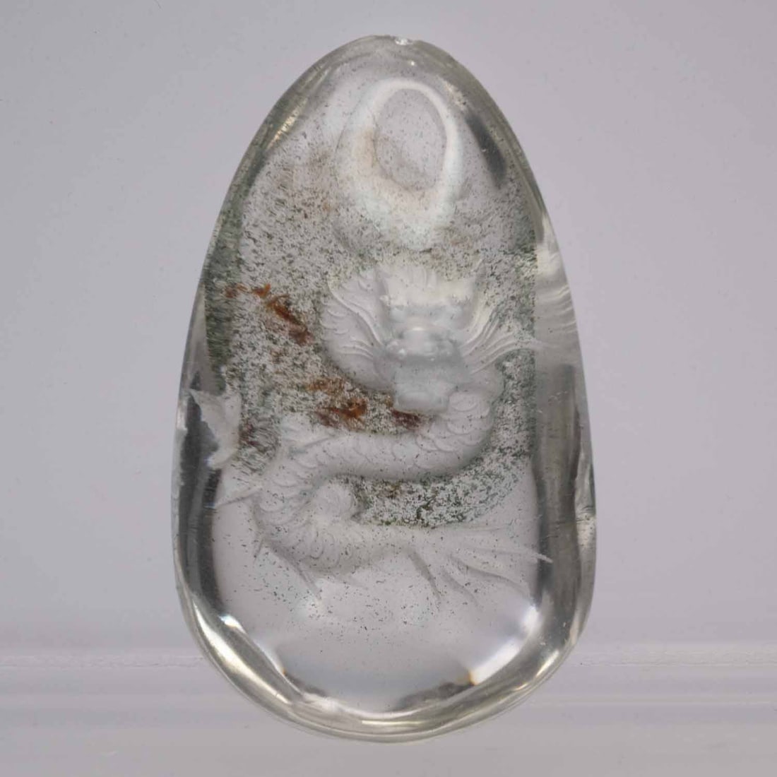 Chinese Carved Reverse Intaglio Crystal Quartz Dragon Pendant: Medium: Crystal Quartz Size: 1x1.6x0.7 inches Age/Detail: Chinese Carved Reverse Intaglio Condition: great overall, check photo for condition reference. Clear rock crystal pendant, reverse-carved from