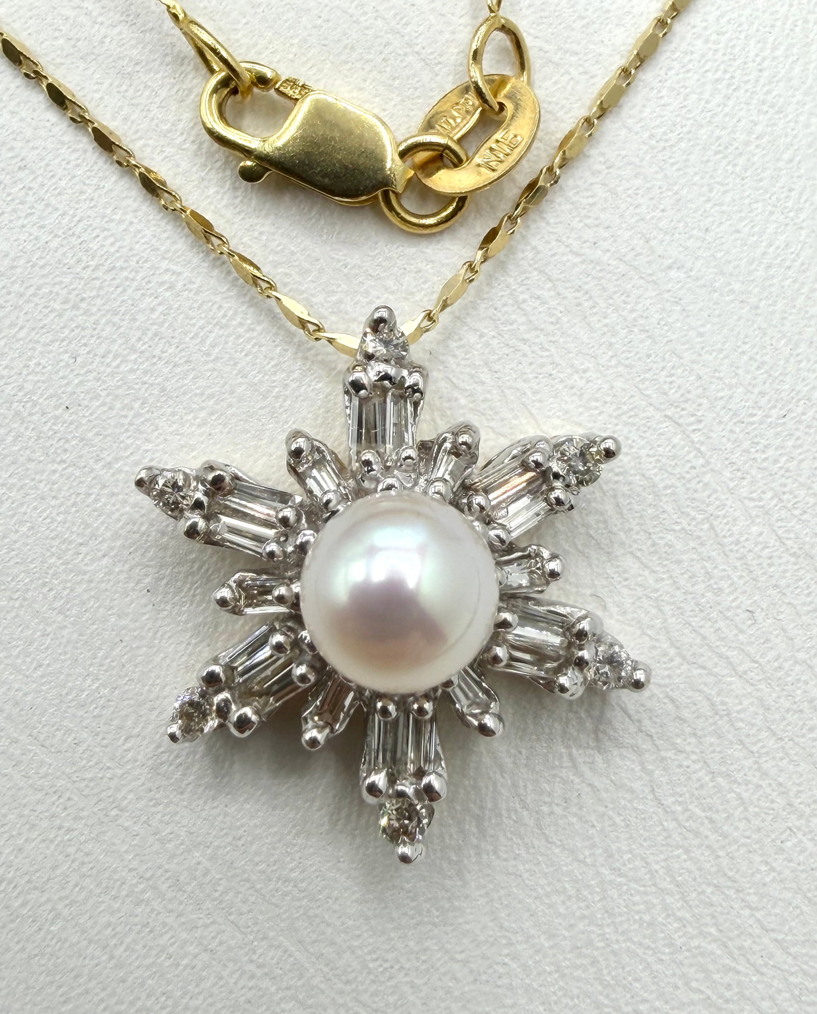National Diamond and Pearl pendant with Chain, 14KT Yellow Gold # 2863: # 2863 National Diamond and Pearl pendant with Chain, 14KT Yellow Gold 24 pieces round and baguette diamond 0.50 carat(t.w.) 1 Piece Pearl: 6 mm 16” chain Pendant and Chain Weight: 4.4 grams(t.w