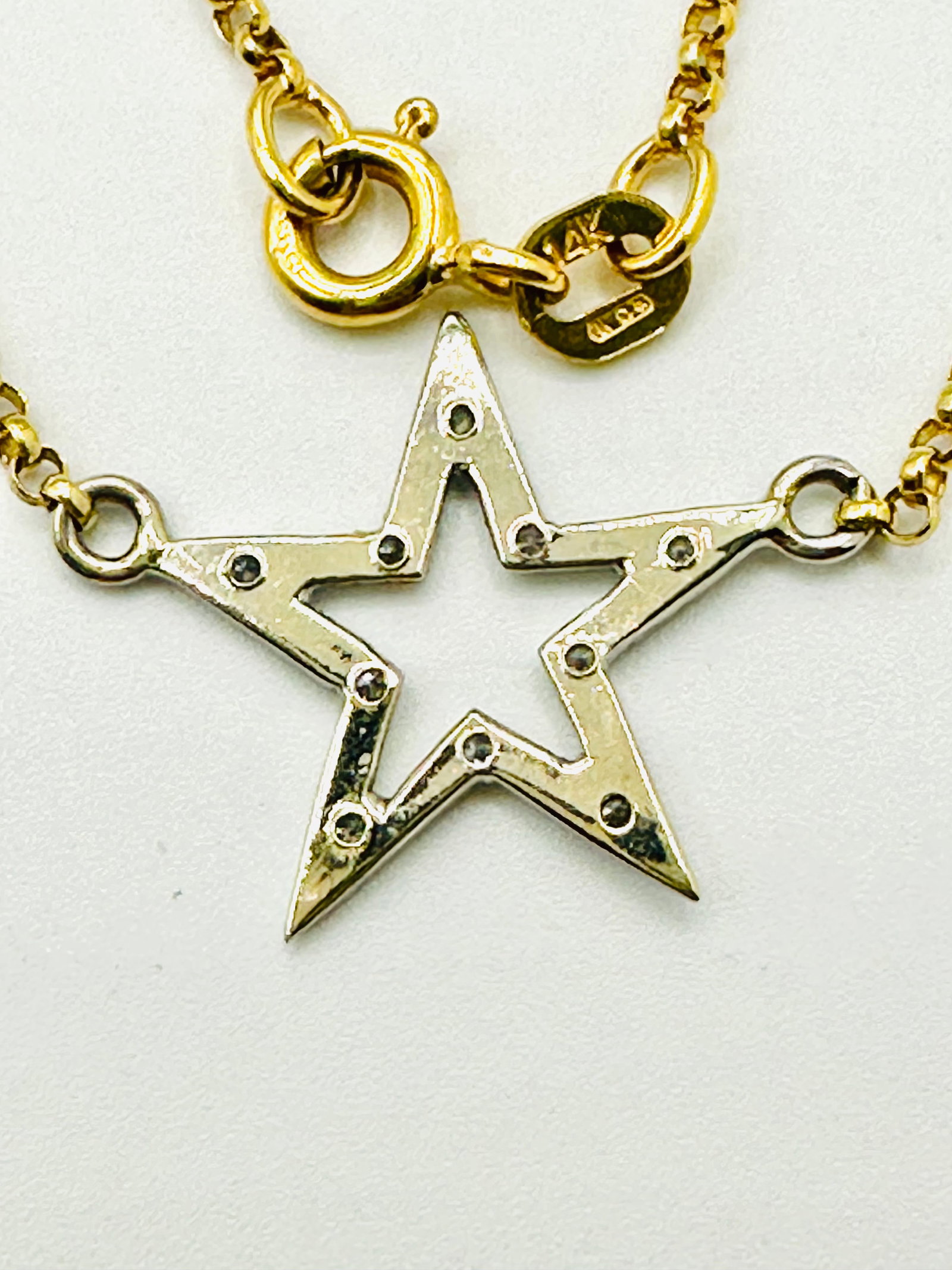 Natural Diamond Star 14KT Yellow Gold Necklace # 2281: # 2281 Natural Diamond Star 14KT Yellow Gold Necklace 10 pieces diamond 0.06 carat( t. w.) 16” chain with spring ring clasp closure Necklace Weight: 3.30 grams( t.w.) Pendant size: 15 mm x 20 mm