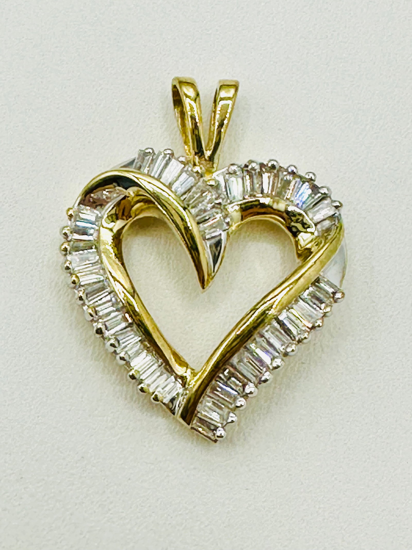 10KT Yellow Gold Natural Diamond Heart Pendant # 2421: # 2421 10KT Yellow Gold Natural Diamond Heart Pendant 38 pieces baguette diamond 0.80 carat(t.w.) Pendant Weight: 3.60 grams Pendant Size: 26 mm X 20 mm