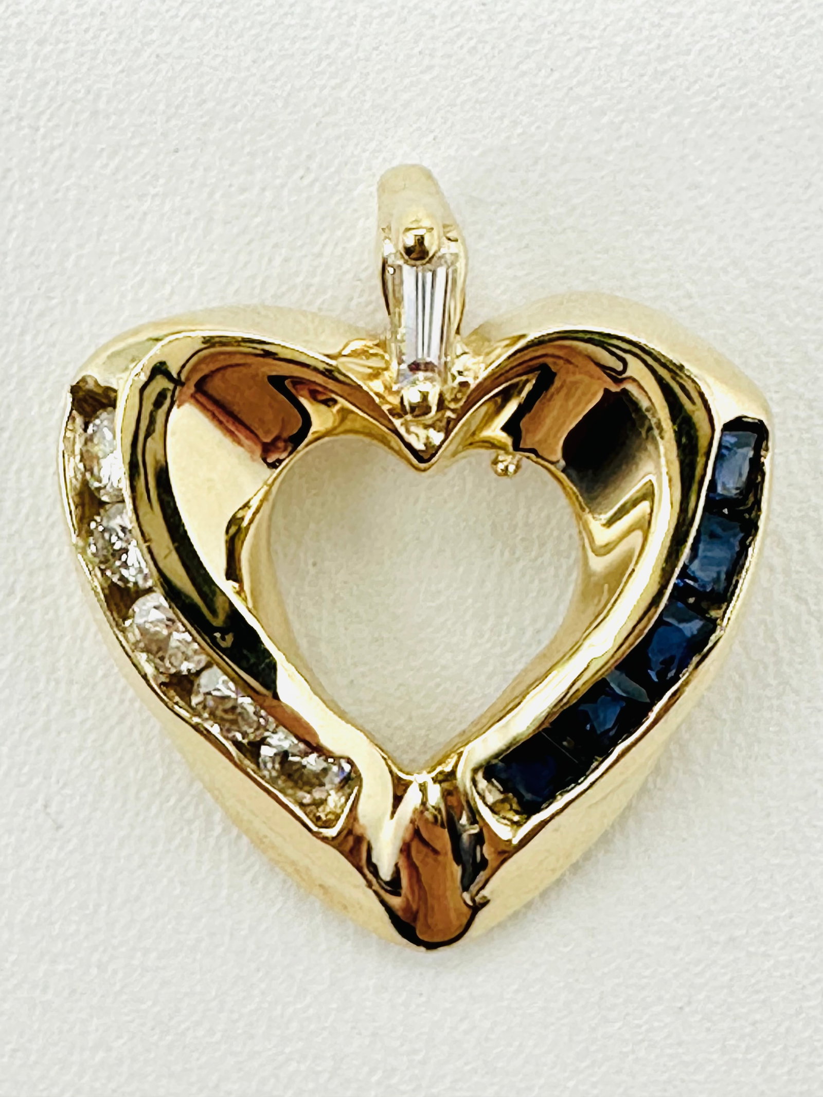 Natural Diamond and Sapphire Heart Pendant,14KT Yellow Gold # 2465: # 2465 Natural Diamond and Sapphire Heart Pendant,14KT Yellow Gold 6 pieces round and baguette diamond 0.26 carat(t.w.) 5 pieces princess diamond 0.30 carat(t.w.) Pendant Weight: 3.40 grams(t.w.) Pend