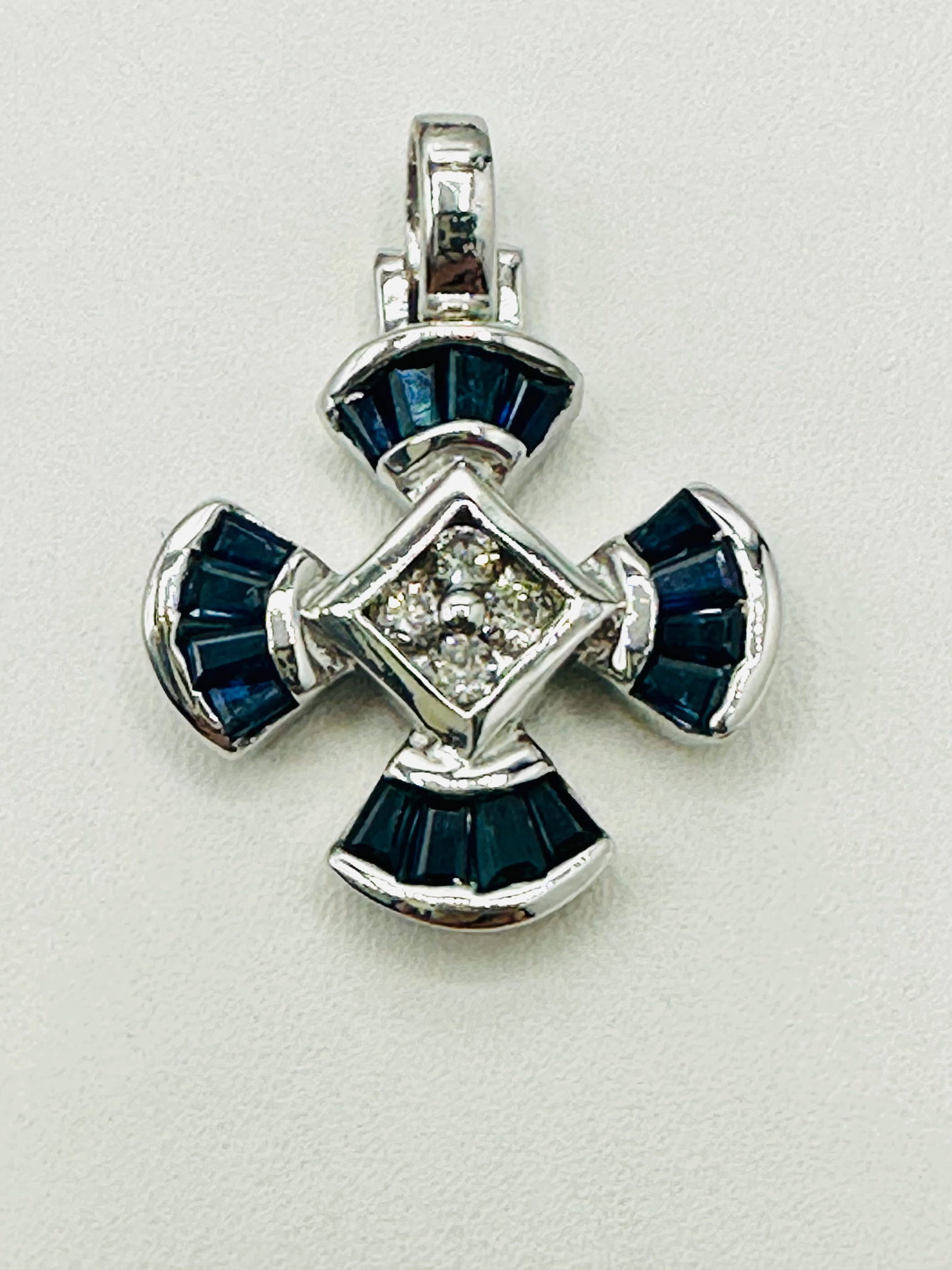 14KT White Gold Natural Diamond and Sapphire Pendant # 2467: # 2467 14KT White Gold Natural Diamond and Sapphire Pendant 4 pieces diamond 0.16 carat(t.w.) 16 pieces baguette sapphire 1.00 carat(t.w.) Pendant Weight: 4.10 grams(t.w.) Pendant Size: 27 mm X 19 mm