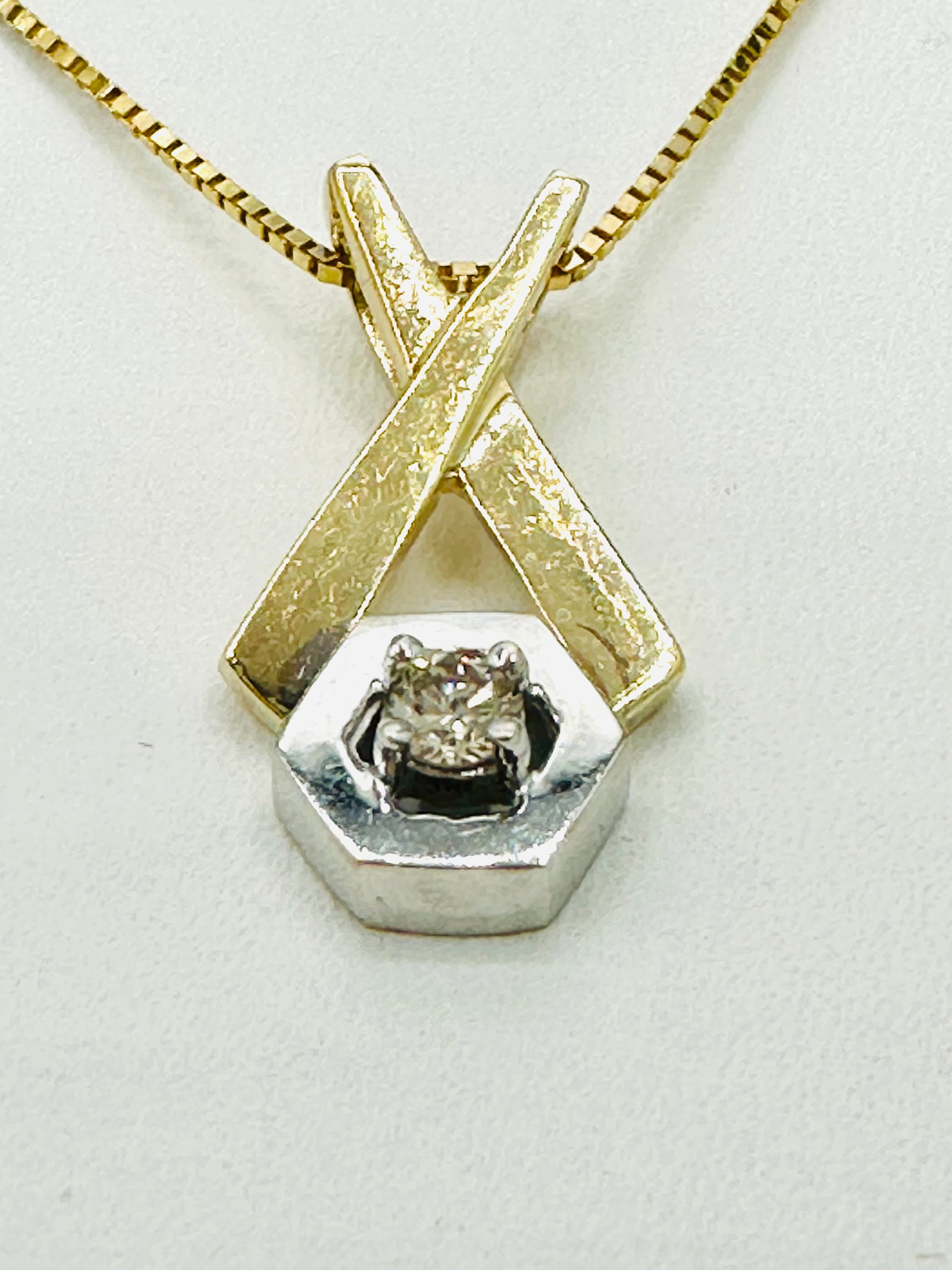 14KT Yellow and White Gold Natural Diamond Pendant, and Chain # 2493: # 2493 14KT Yellow and White Gold Natural Diamond Pendant, and Chain 1 piece diamond 0.07 carat 16â€? box chain with spring lock Pendant and Chain Weight: 2.70 grams(t.w.) Pendant Size: 18.5 mm 