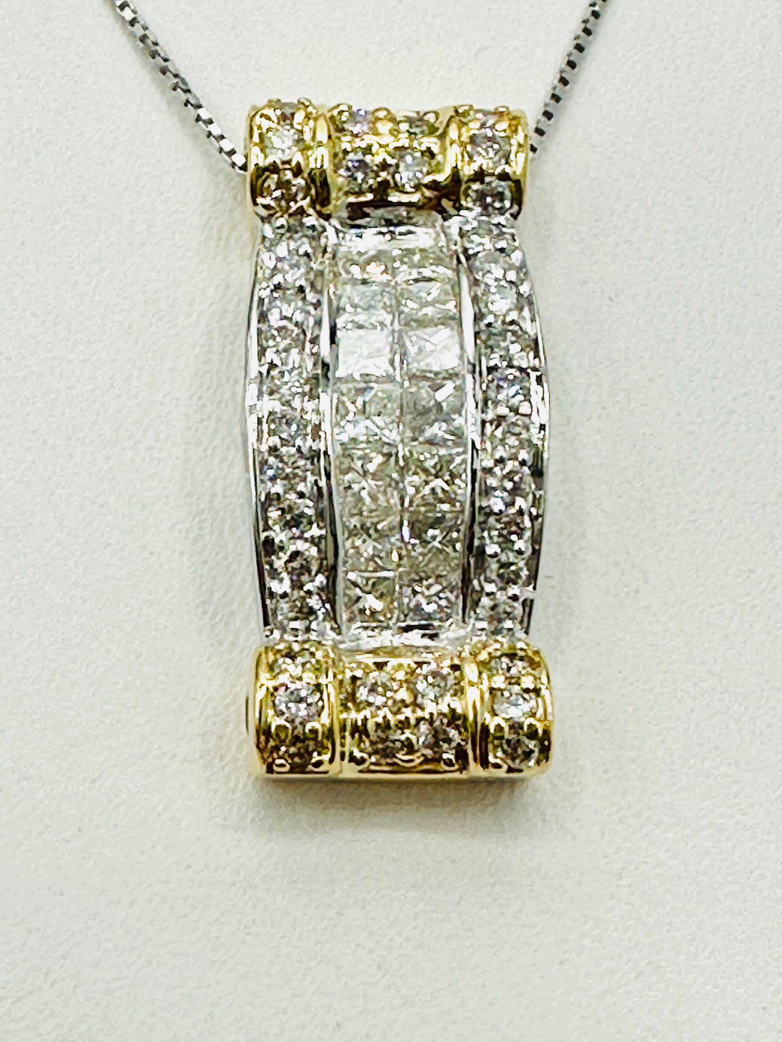 Natural Diamond Slide Pendant and Chain 14KT Yellow and White Gold # 2549: # 2549 Natural Diamond Slide Pendant and Chain 14KT Yellow and White Gold 54 pieces round and baguette diamond 1.00 carat( t.w.) 16â€? chain with spring ring clasp closure Pendant and Chain Weig