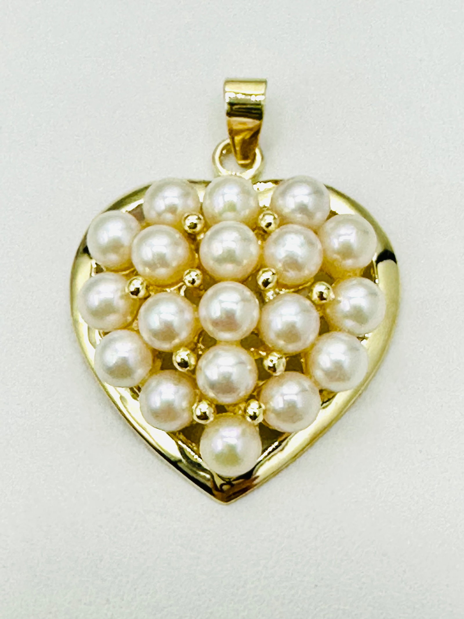 14KT Yellow Gold Pearl Heart Pendant # 2550: # 2550 14KT Yellow Gold Pearl Heart Pendant 19 pieces freshwater Pearl Pendant Weight: 3.2 grams (t.w.) Pendant size: 27 mm X 20 mm