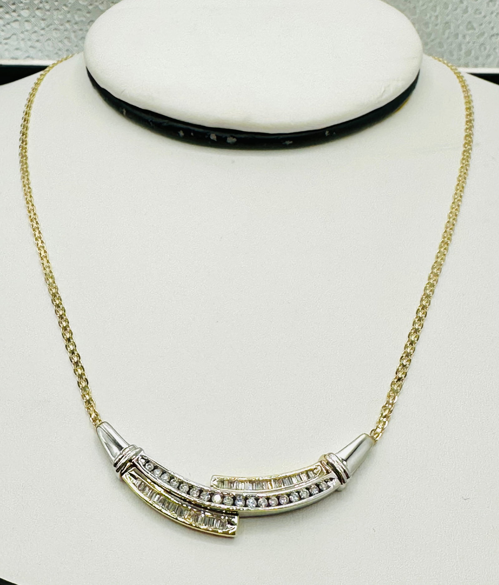 Natural Diamond Necklace, Yellow and White Gold # 2668: # 2668 Natural Diamond Necklace, Yellow and White Gold 57 pieces round and baguette diamond 1.00 carat( t.w.) Lobster lock clasp closure Weight: 8.20 grams (t.w.) 18â€?