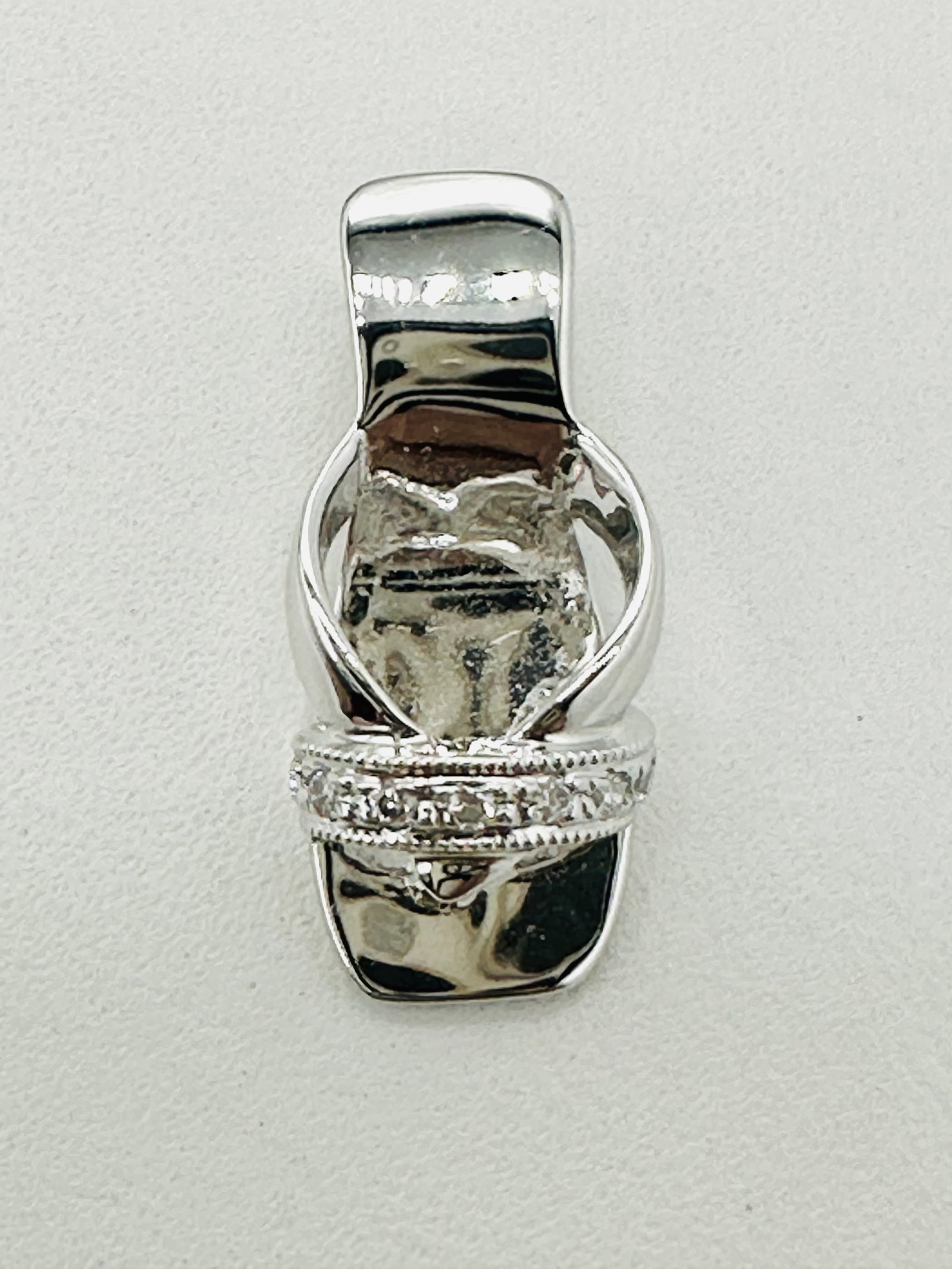 18KT White Gold, Natural Diamond Slipper Pendant # 2704: # 2704 18KT White Gold, Natural Diamond Slipper Pendant 7 pieces diamond 0.04 carat(t.w.) Pendant Weight: 2.00 grams (t.w.) Pendant size: 17 mm X 8 mm