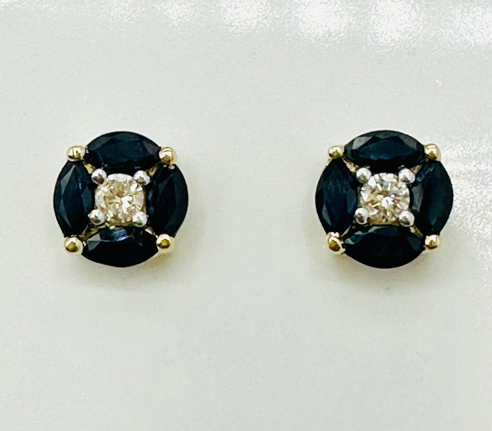 14KT Yellow Gold,Pair of Natural Diamond and Sapphire Round Earrings # 2744: # 2744 14KT Yellow Gold,Pair of Natural Diamond and Sapphire Round Earrings 2 pieces diamond 0.16 carats(t.w.) 8 pieces marquis sapphire 1.00 carat(t.w.) Post Black Earrings Weight: 1.50 grams(t.w.) E