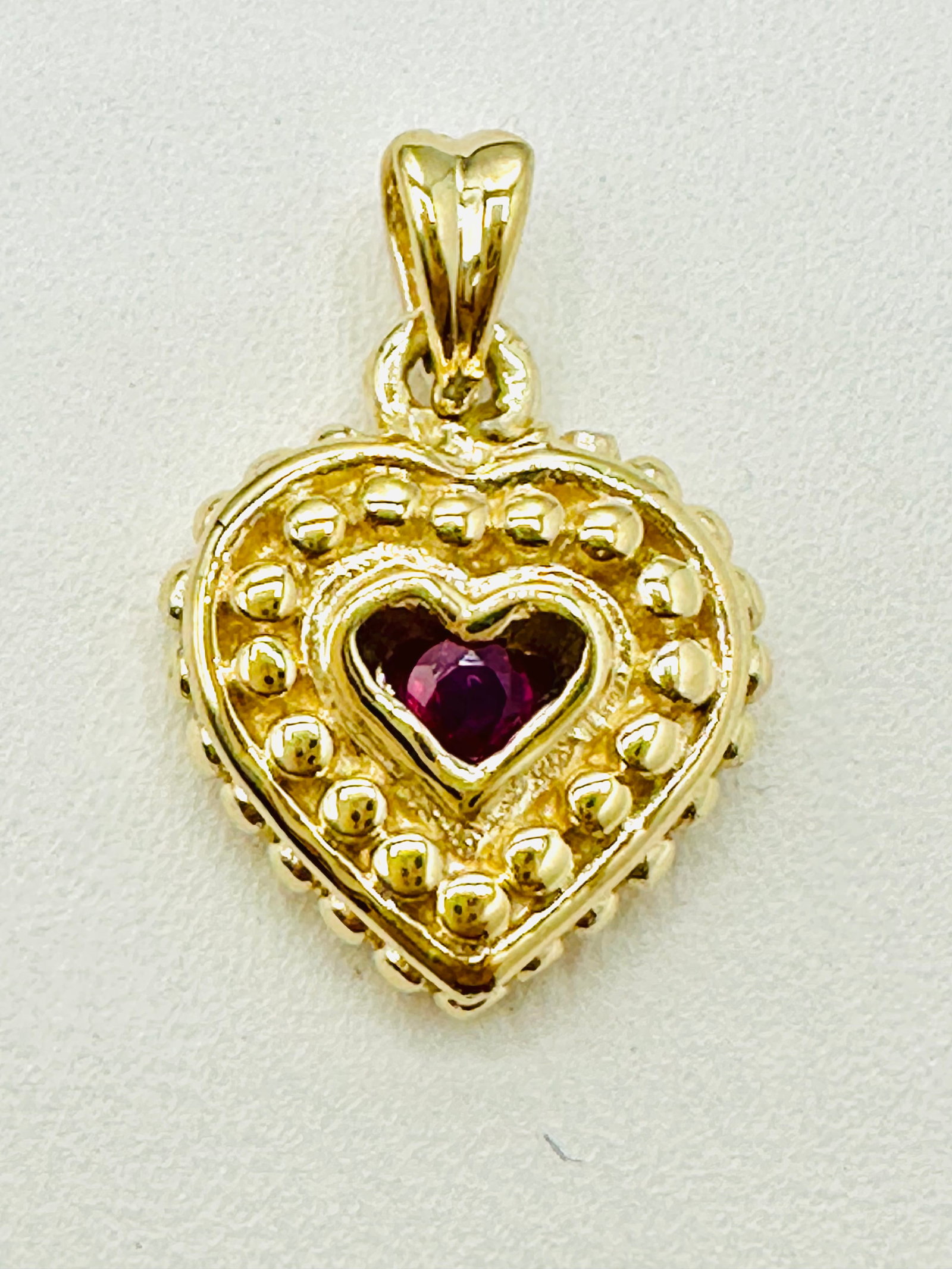 14KT Yellow Gold, Natural Ruby Heart Pendant # 2746: # 2746 14KT Yellow Gold, Natural Ruby Heart Pendant 1 piece ruby 0.15 carat Pendant Weight: 3.40 grams (t.w.) Pendant size: 19 mm X 13mm