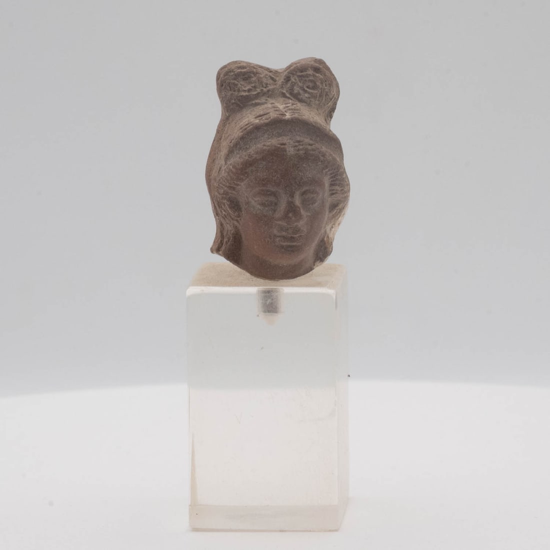 Antique Chinese Tang Dynasty Terracotta Female Attendant Head Fragment on Acrylic Stand: Medium: Terracotta Size: 1x1.3x2.7 inches Age/Detail: Antique Chinese Tang Dynasty Condition: great overall, check photo for condition reference. Provenance: Collection from Estate in Williamsburg Liv