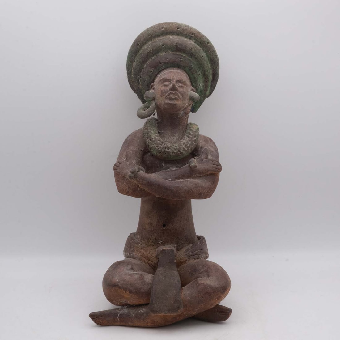 Pre-Columbian Ceramic Seat Figure, Tairona Style: Medium: Ceramic Size: 6x6x11 inches Age/Detail: Pre-Columbian Condition: great overall, check photo for condition reference. The surface presents earthen brown tones with areas of green mineral accret
