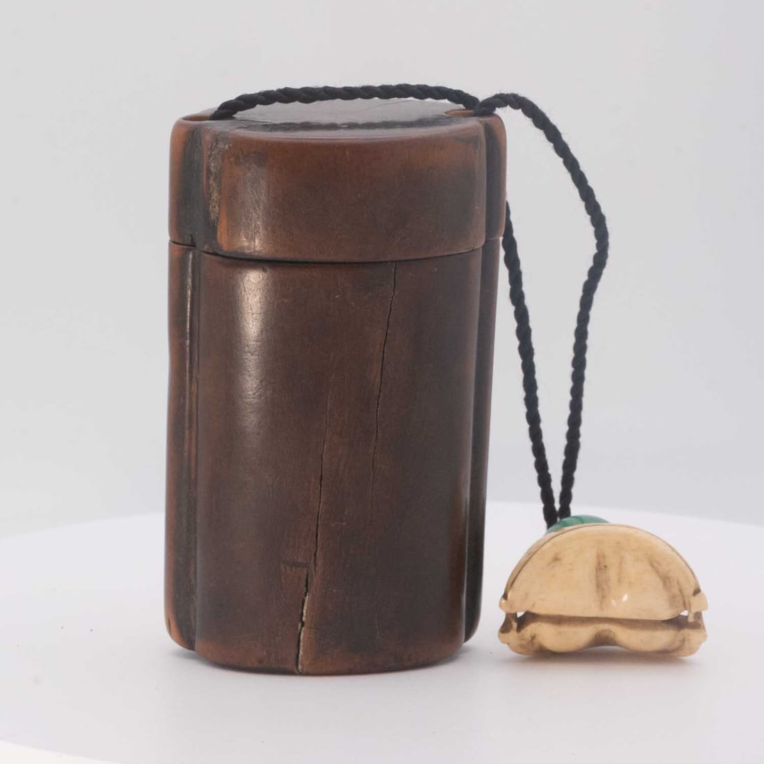 Antique Japanese Wood Tonkotsu Tobacco Container with Carved Bone Netsuke and Ojime: Medium: Wood Size: 2.5x5x1.8 inches Age/Detail: Antique Japanese Condition: check photo for condition reference. Long age-related split extends through the wooden body and base, with additional small 