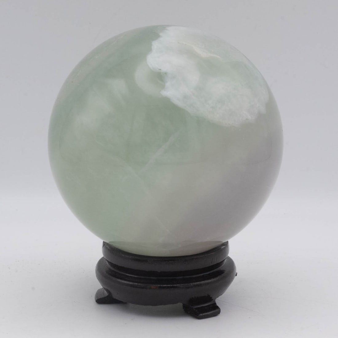 Green and White Fluorite Sphere on Wood Stand: Medium: Green and White Fluorite Size: 3.3x3.3x4.2 inches Age/Detail: Condition: great overall, check photo for condition reference. Provenance: Collection from Estate in Williamsburg LiveShipping is 
