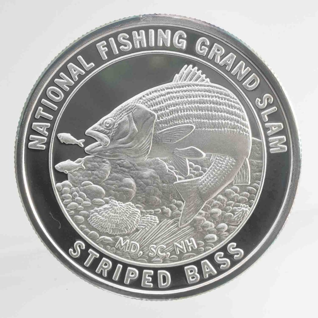 North American Fishing Club Striped Bass 1oz SIlver Round: MLC01434 Provenance: Acquired from reputable coin dealers. Subject: North American Fishing Club Striped Bass 1oz SIlver Round Medium: 999 SIlver Year: Condition: MS Note: Any condition statement is gi
