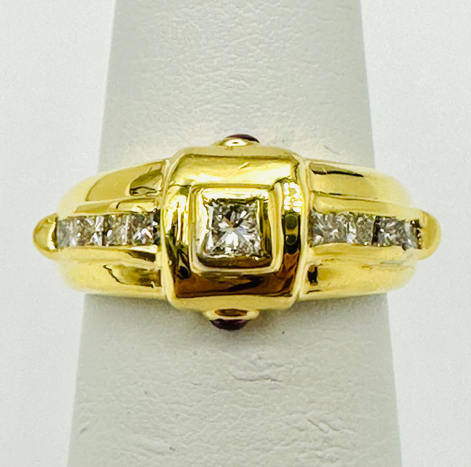 Natural Diamond and Ruby Ring, 18KT Yellow Gold # 2414: # 2414 Natural Diamond and Ruby Ring, 18KT Yellow Gold 9 pieces princess diamond 0.55 carat(t.w.) 2 pieces cabochon ruby 0.08 carat (t. w.) Ring Weight: 5.6 grams(t.w.) Ring Size: 4.75