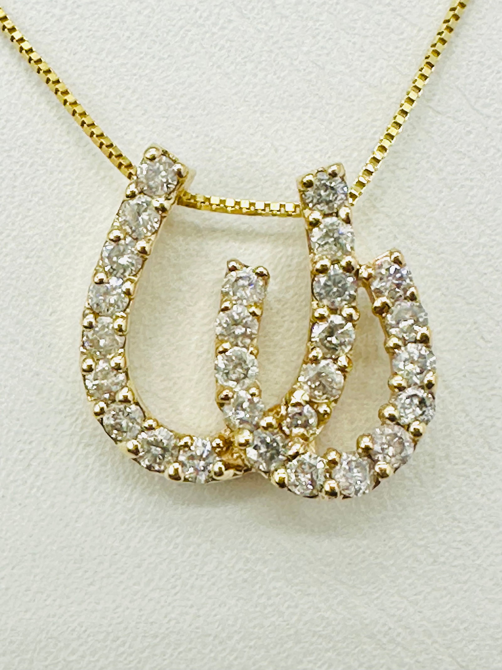 Natural Diamond 14KT Yellow Gold Double Horse Shoes Pendant and Chain # 2473: # 2473 Natural Diamond 14KT Yellow Gold Double Horse Shoes Pendant and Chain 27 pieces diamond 0.65 carat(t.w.) 16â€? box chain with spring lock clasp closure Pendant Weight: 2.10 grams(t.w.) Pe