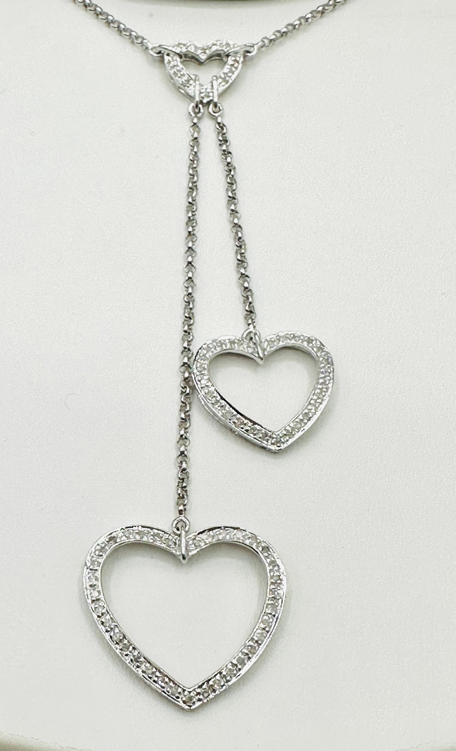 Natural Diamond Triple Heart Necklace, 14KT White Gold # 2501: # 2501 Natural Diamond Triple Heart Necklace, 14KT White Gold 74 pieces diamond 0.35 carat(t.w.) Length 16â€? chain with lobster lock clasp closure Necklace Weight: 5.80 grams(t.w.)