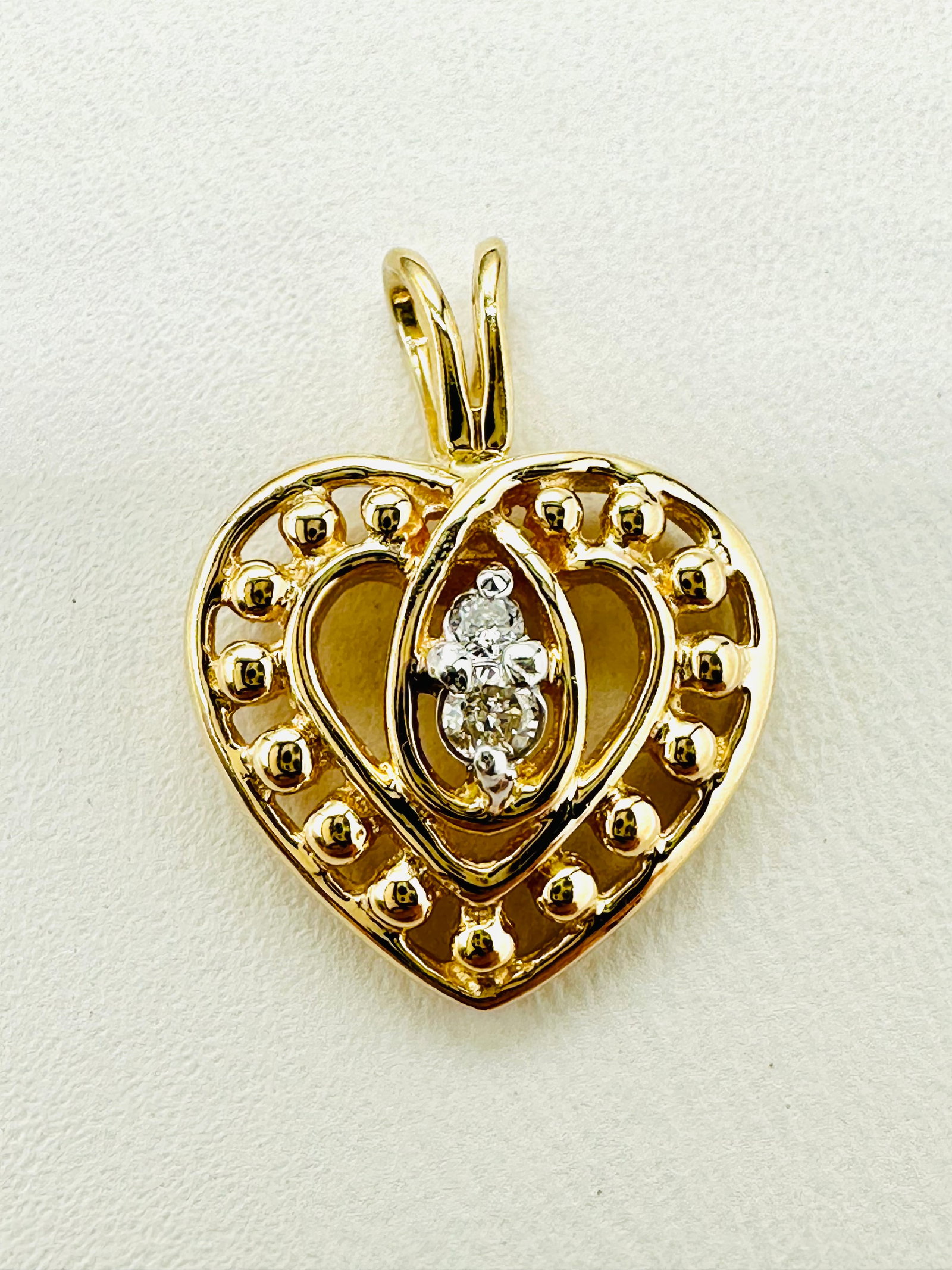 Natural Diamond Heart Pendant,14KT Yellow Gold # 2512: # 2512 Natural Diamond Heart Pendant,14KT Yellow Gold 2 pieces diamond 0.05 carat(t.w.) Pendant Weight: 1.40 grams(t.w.) Pendant size: 16.5 mm X 12.5 mm