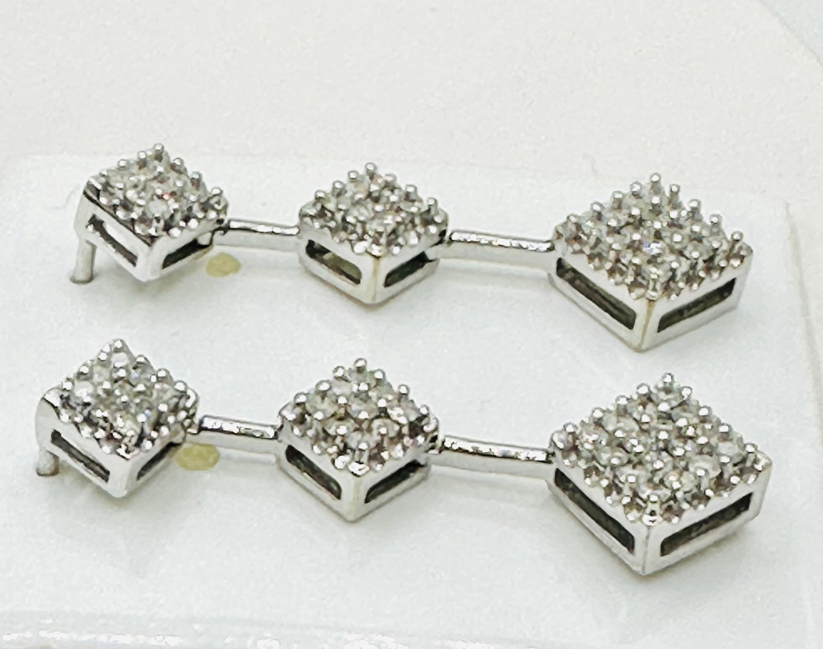 Pair of Natural Diamond Drop Earrings, 10KT White Gold # 2612: # 2612 Pair of Natural Diamond Drop Earrings, 10KT White Gold 68 pieces princess diamond 1.00 carat(t.w.) Earrings Weight: 6.20 grams(t.w.) Screw back closure Earrings Size: 35 mm X 10 mm