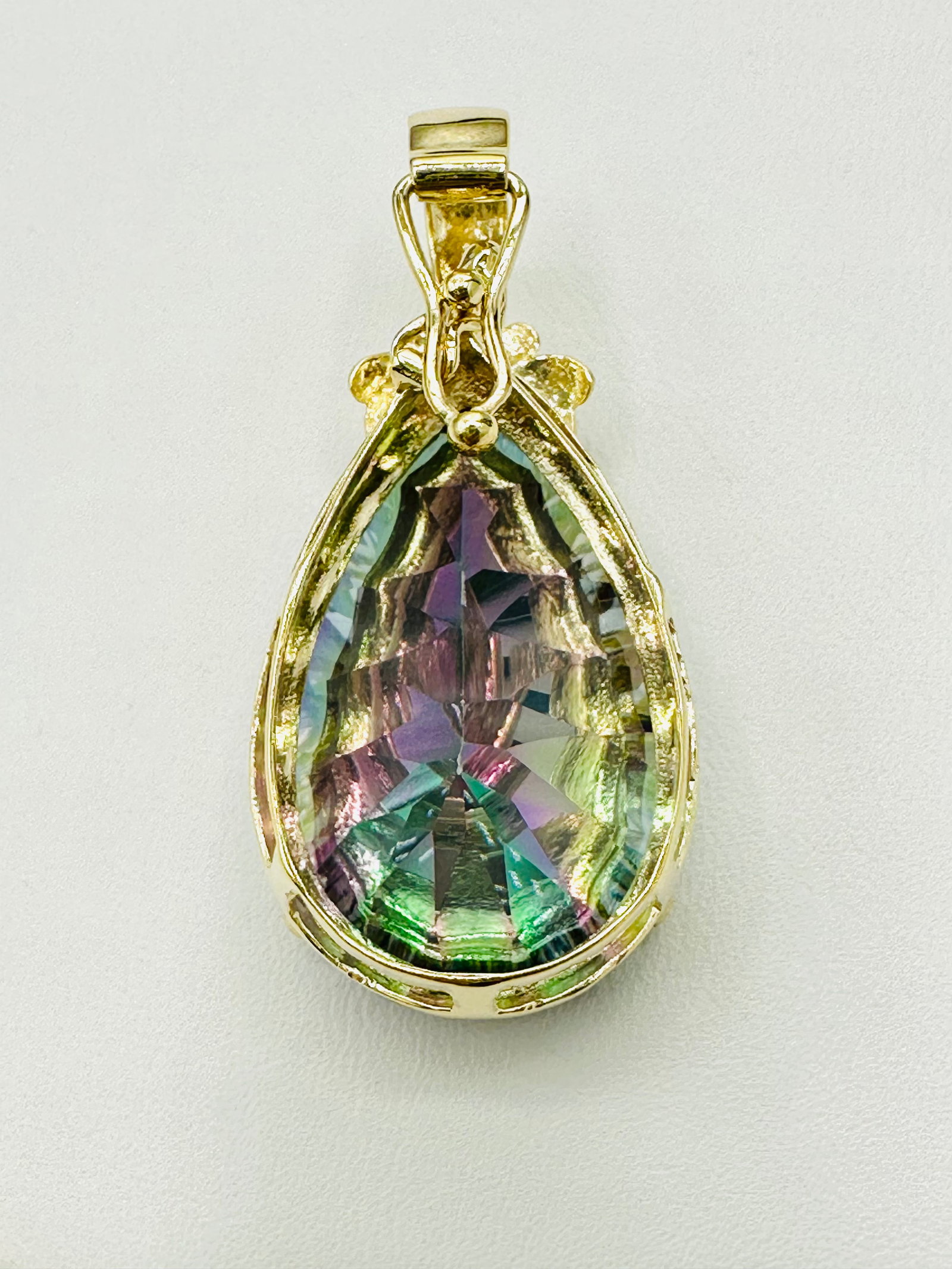 14KT Yellow Gold Mystic Quartz Pendant # 2650: # 2650 14KT Yellow Gold Mystic Quartz Pendant 1 piece pear shaped mystic quartz Pendant Weight: 10.70 grams (t.w.) Pendant size: 38 mm X 19 mm