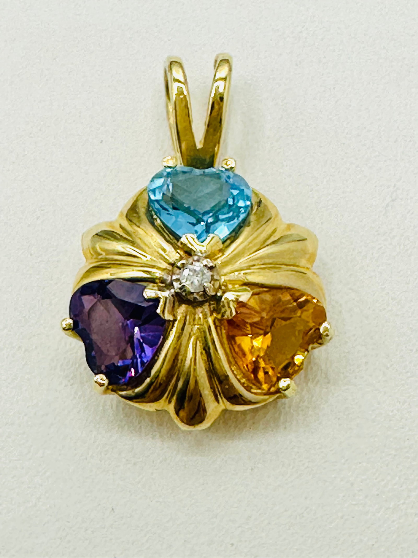 14KT Yellow Gold, Natural Diamond and Multi Gemstone Pendant # 2713: # 2713 14KT Yellow Gold, Natural Diamond and Multi Gemstone Pendant 1 piece diamond 1 piece heart shaped amethystï½¤blue topaz and Citrine Pendant Weight: 1.80 grams (t.w.) Pendant size: 19 m